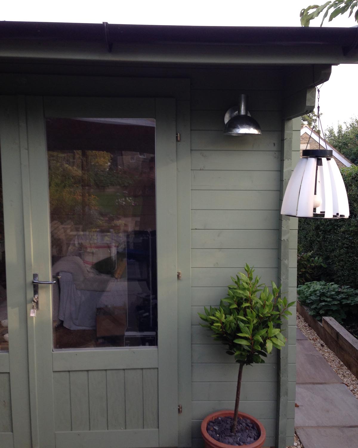 Green garden shed with light. NBG Digital Home. Electric Vehicle chargers, Solar and Heat Pumps, General Electrical Services in the South West.